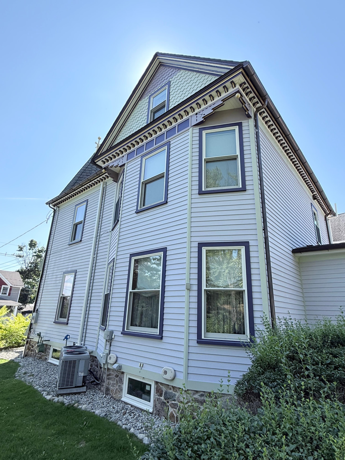 Side gable with painted brackets, dentil cornice and purple window casings