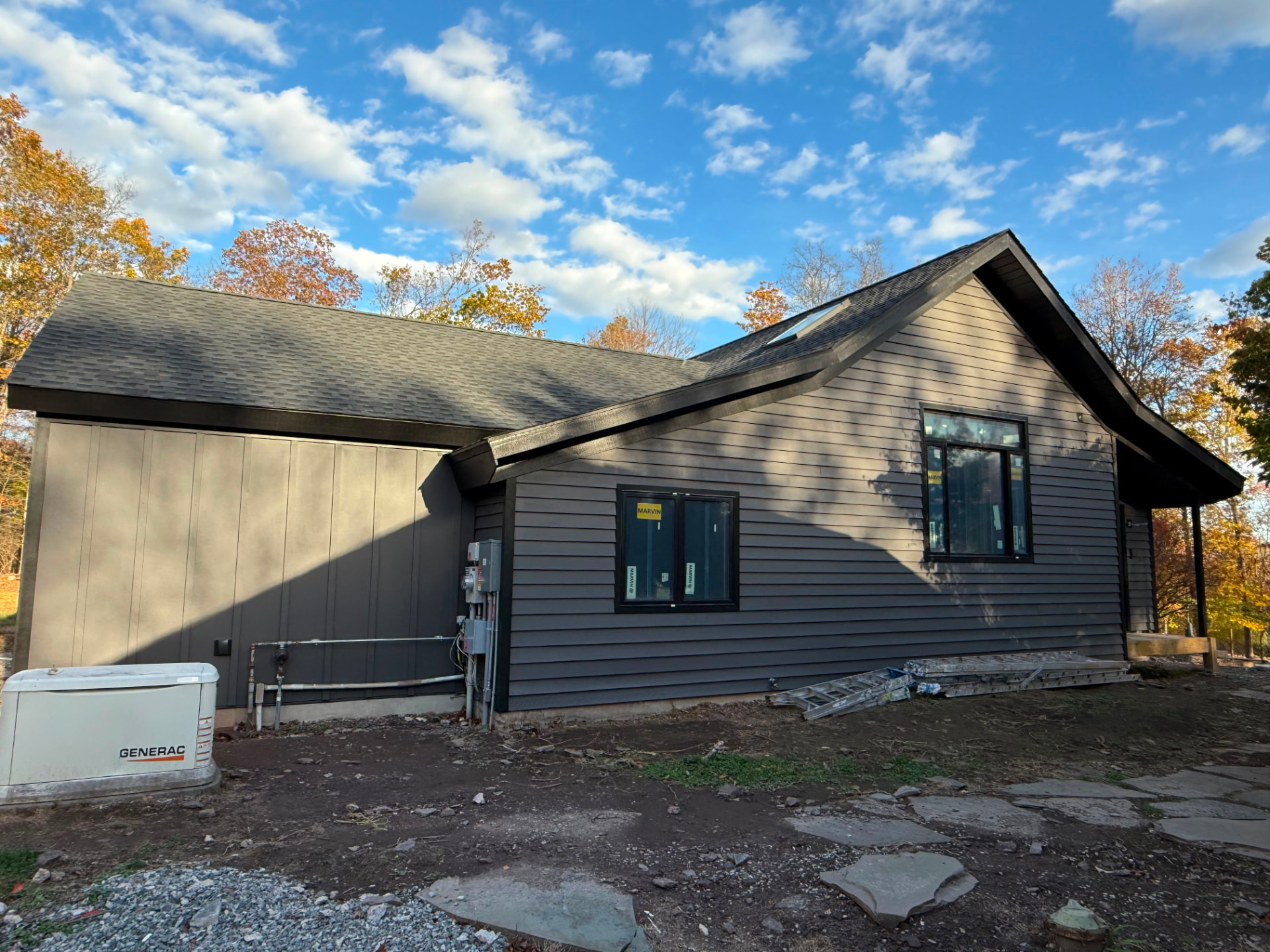 Closer view of charcoal lap siding and board-and-batten