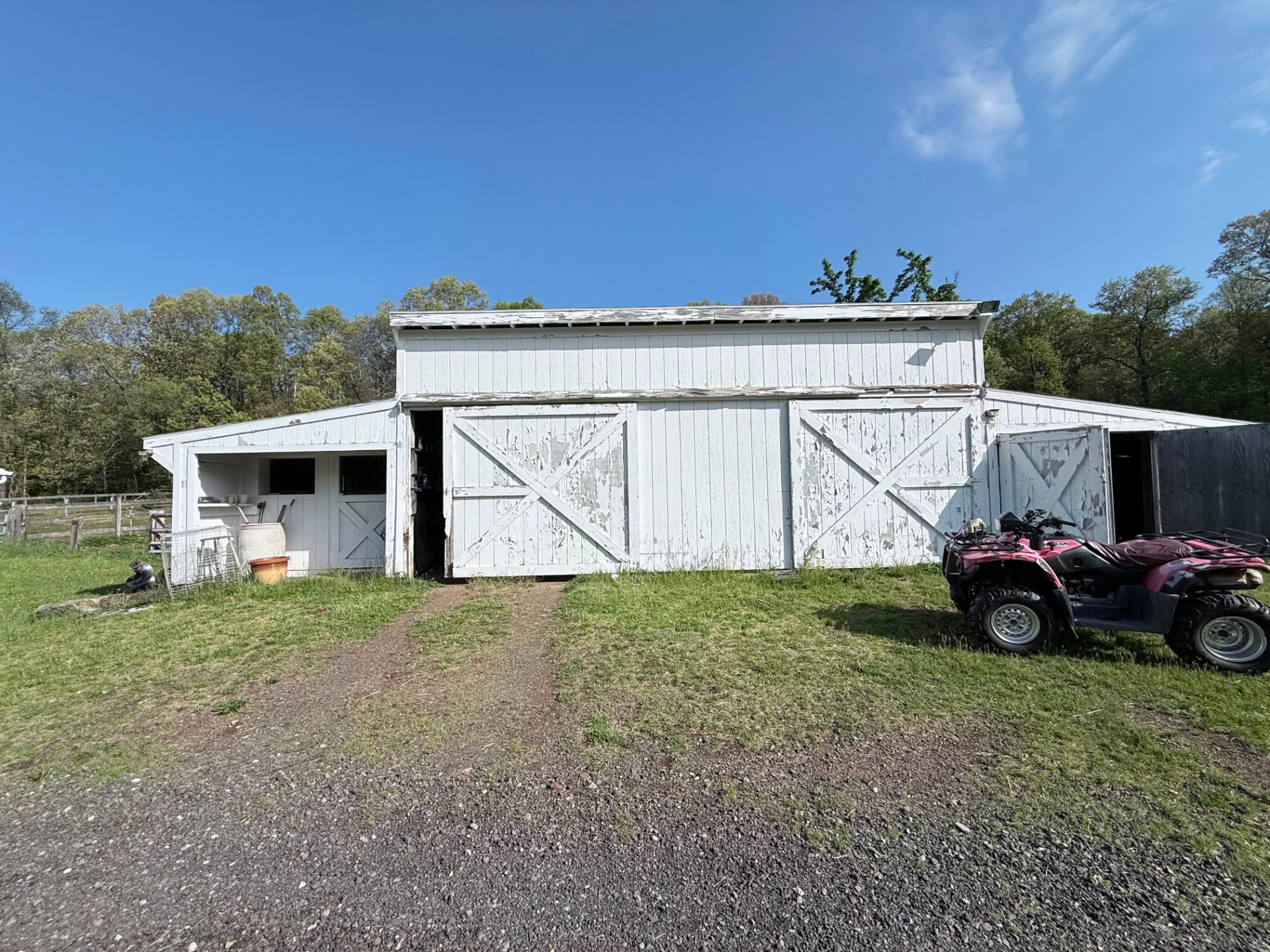 Second barn with peeling paint on large X-braced sliding doors