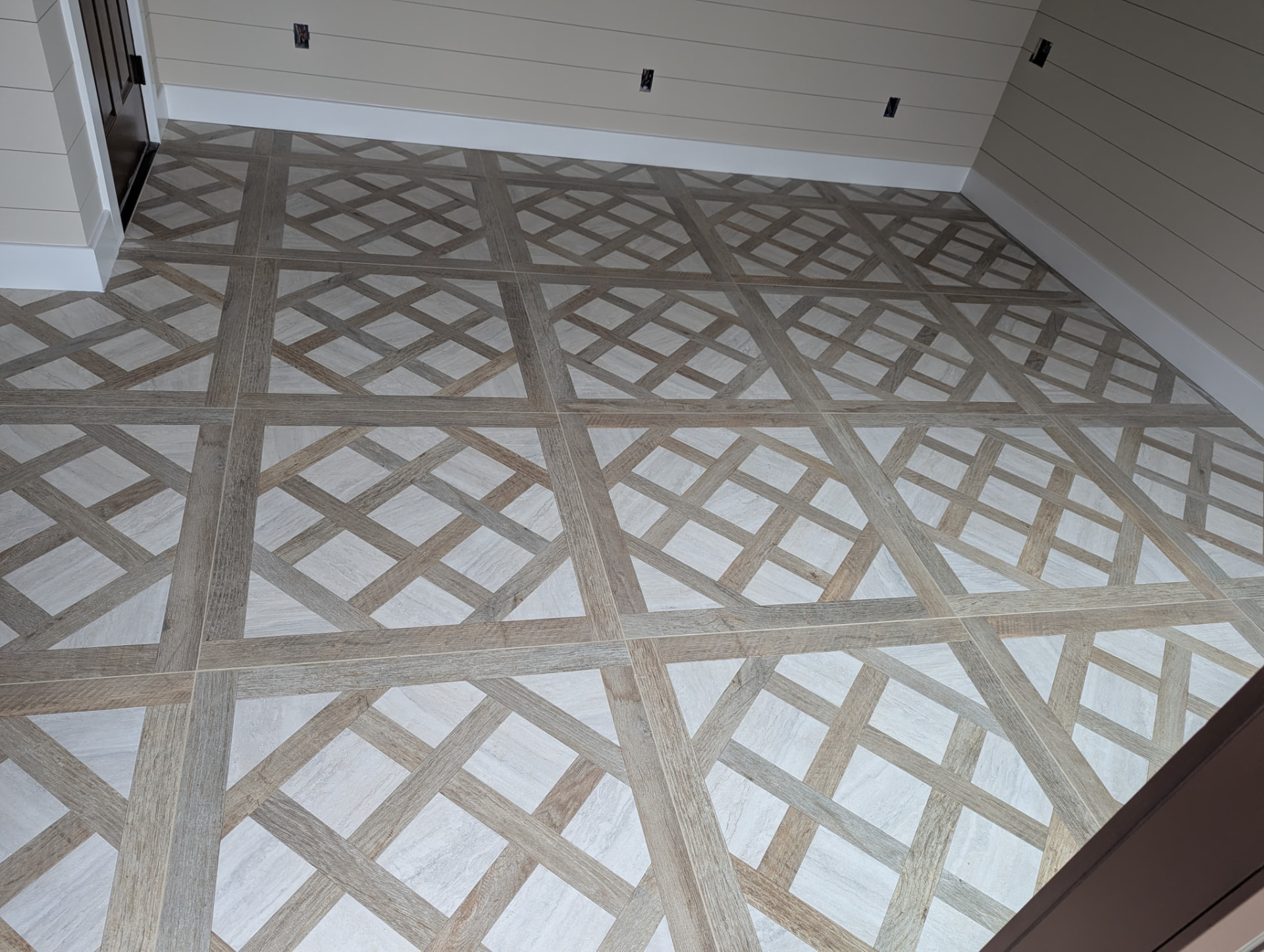 Lattice-pattern porcelain tile floor with wood-look and stone-look tiles
