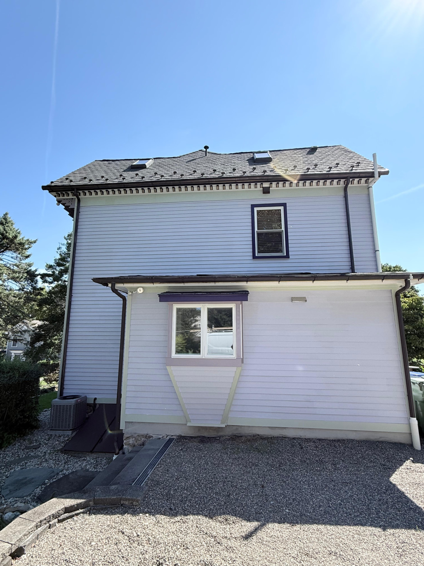 Side addition with lavender clapboard, mint trim and purple window hood