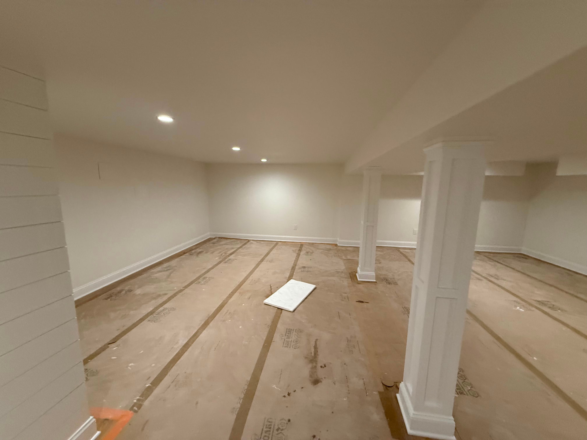 Wrapped basement columns finished in white semi-gloss with crisp baseboards