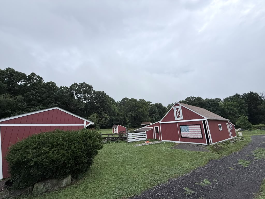 Red barns with white trim and the American flag panel